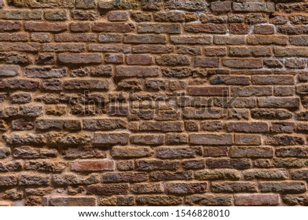 Age grunge house stone boulder background. Solid uneven mosaic surface stacked wall.Medieval Europe mansion yard. Dirty rural tower rock texture. Fortified district vintage tower facing castle for 3d