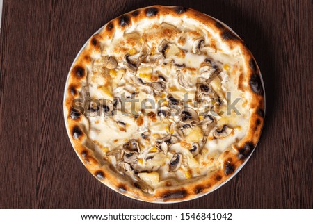 Cheap pizza with mushrooms, pineapple, and corn.