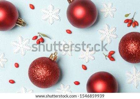 Red christmas ornaments on blue background, top view. Christmas, winter holiday, new year concept. 