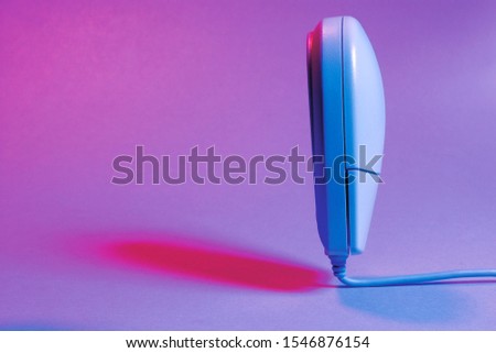  Picture of a white computer mouse standing straight up on a coloured background