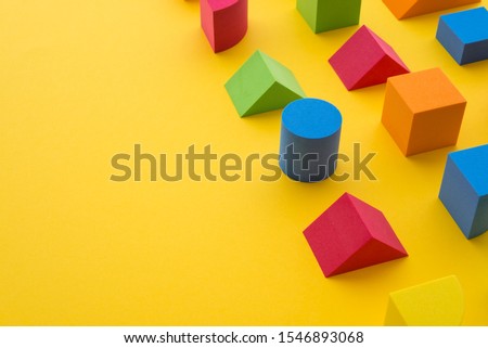 Set of colorful geometric cube or block toy on yellow background with copy space. Abstract pattern design composition by shape and form. Education, business solution, creative design product concept.