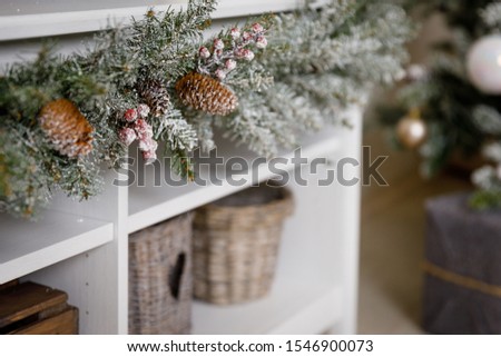 Modern black and white interior design room with Christmas and New Year decorations, toys, gifts, snow-covered fir tree, garlands. Winter holidays composition. Close up details.