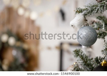 Modern black and white interior design room with Christmas and New Year decorations, toys, gifts, snow-covered fir tree, garlands. Winter holidays composition. Close up details.