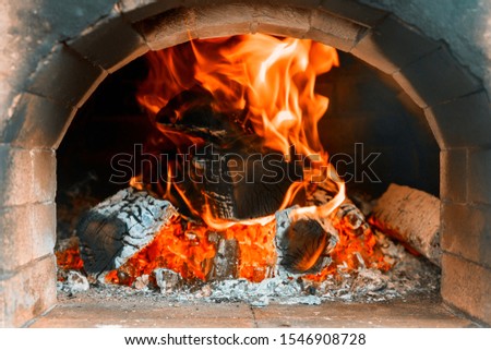 Traditional Italian pizza oven into a wood fire in restaurant
