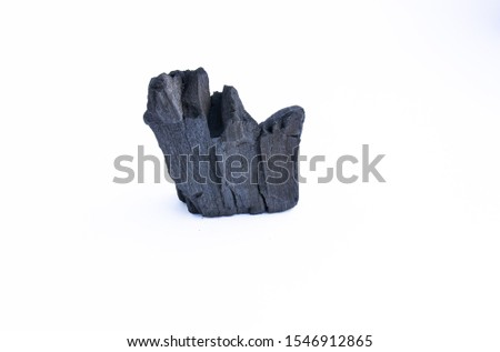 black coal on a white background. a porous black solid consisting of an amorphous form of carbon, obtained as a residue by heating wood, bone or other organic matter in the absence of air.