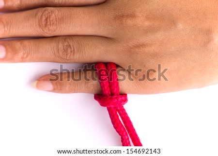 Stock Photo - open hand with red ribbon, don't forget