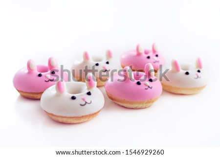 Cute animal shaped mini donuts coated with icing glaze isolated on white background.