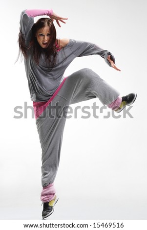 cool looking and stylish hip-hop dancer posing on white background
