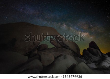 A beautiful shot of silhouettes of huge stones under the sky with a lot of stars