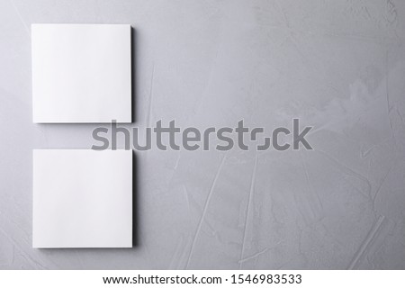 Blank note papers on light grey background, flat lay. Mock up for design