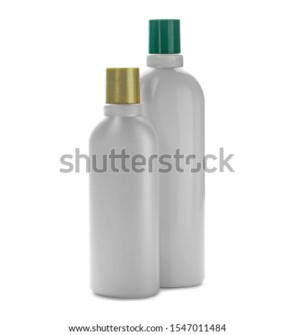 Bottles with cosmetic products on white background. Mockup for design