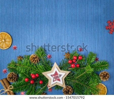 Christmas composition with gifts, red balls, pine cones, fir branches and snowflakes on a blue background