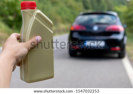 Picture of the man holding  an oil bottle