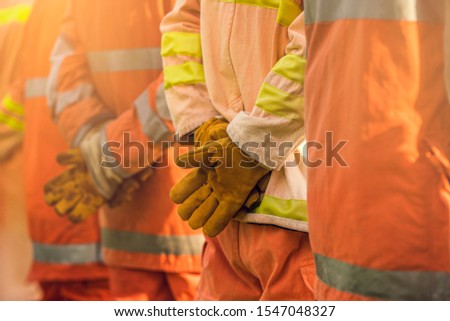 Close Up hand gloves heat resistant,  Team fireman stand in row, Firefighter training fighting fire. Team work. Royalty-Free Stock Photo #1547048327
