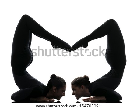 two women contortionist practicing gymnastic yoga in silhouette   on white background