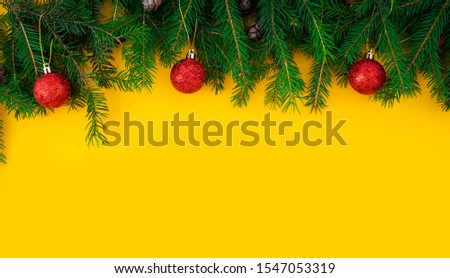 Christmas and New Year yellow background with fir border