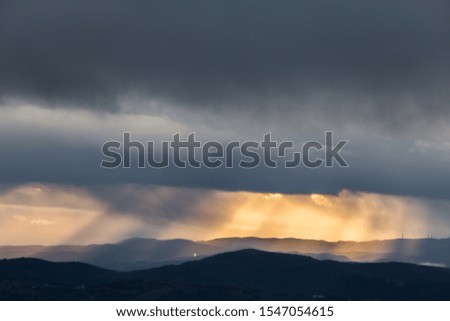 Sunrays coming over mountains in Umbria (Italy) with beautiful golden hours colors.