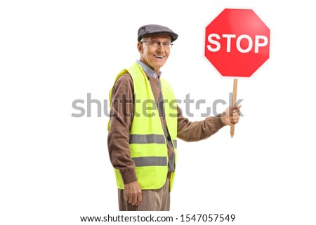 Elderly man wearing safety vest and holding a stop sign isolated on white background