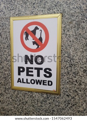 warning sign . no pets allowed in a frame