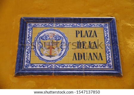 The street sign of Plaza de la Aduana. It means 'Customs Square' in English. Plaza de la Aduana is the oldest and biggest square in Cartagena.