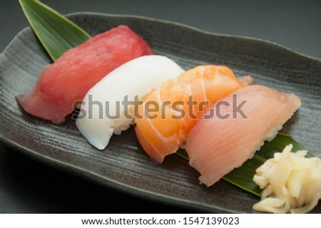 This is a picture of Japanese sushi. The ingredients for this shushi are Tuna, Squid, Salmon and Yellowtail.