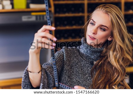 Portrait of smiling female interior designer sitting at office desk.