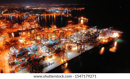 Aerial drone night shot of illuminated industrial container cargo terminal
