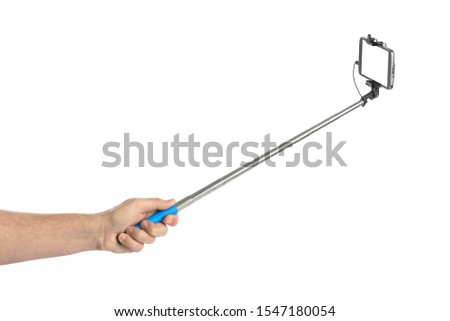 Hand and smartphone with selfie stick isolated on white background