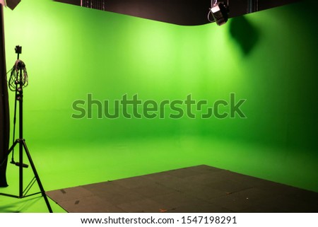 Interior of Modern Film Studio with Green Screen and Light Equipment - Photo