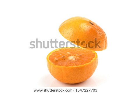 Cut orange fruits on a white background.