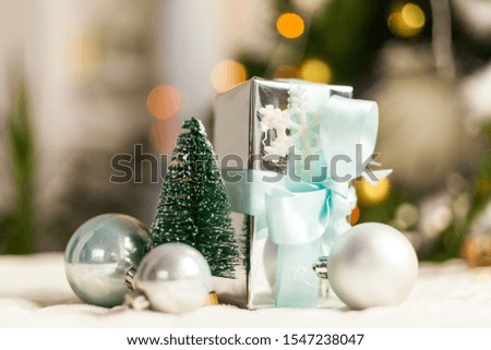 Pearl Grey Christmas Tree and balls close up on bokeh background