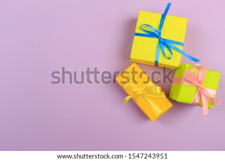 Different colored gift box on color background. Top view of various present boxes on minimal background. Birthday, Christmas, wedding, valentine, romantic gifts
