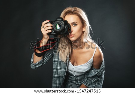 Girl with a camera on a black background