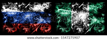 Russia, Russian vs Nigeria, Nigerian New Year celebration sparkling fireworks flags concept background. Combination of two states flags.
