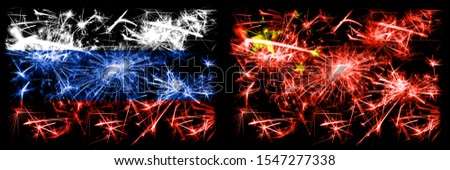 Russia, Russian vs China, Chinese New Year celebration sparkling fireworks flags concept background. Combination of two states flags.
