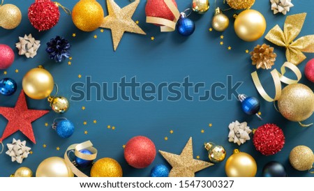 Christmas frame border with balls, stars, ribbon on blue background. Flat lay, top view, copy space. Xmas banner mockup, flyer, poster template.