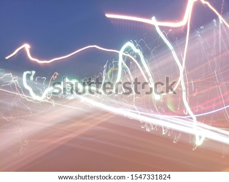 Abstract speed motion in urban highway road tunnel, blurred motion toward the light. Light trails, abstract background.