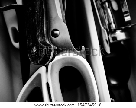 Black and white photo of cutlery and other kitchen utensils, focus on details.