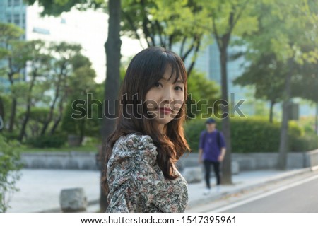 a Pretty Asian Girl looks at something