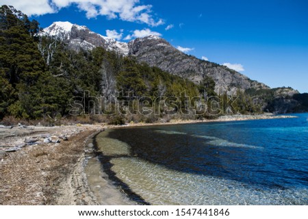 Lake at Lake District in Bariloche, Argentina. This relaxing lake is located inside Circuito Chico at Tacul Village. Calm water around the Andes mountains