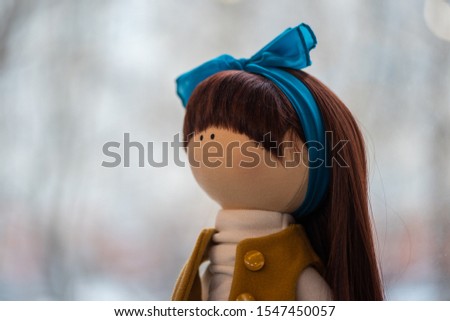 doll with a blue bow on the background