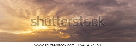 Panoramic overcast morning cloudy dramatic sky and golden sun light nature background
