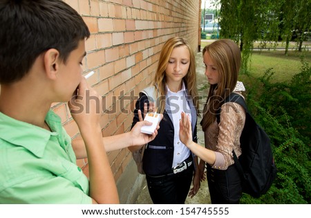 Young girls stop smoking in the street