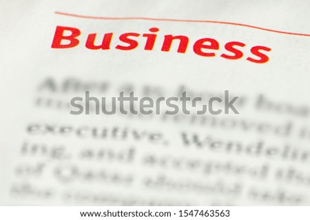 Word Business on newspaper. Red text business.