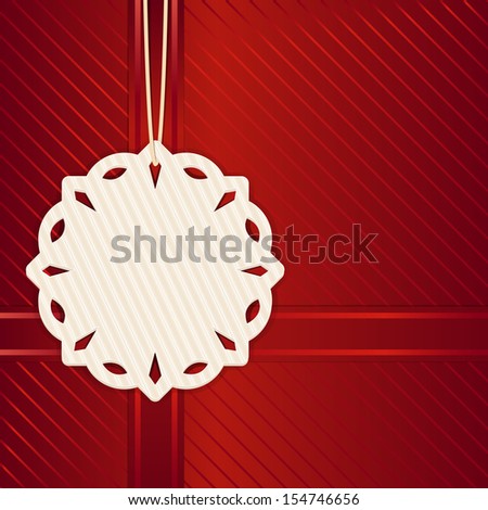 Paper Snowflake Christmas gift label on a red background with ribbons