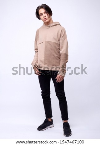 photo of man wearing beige hoodie isolated on white background.
