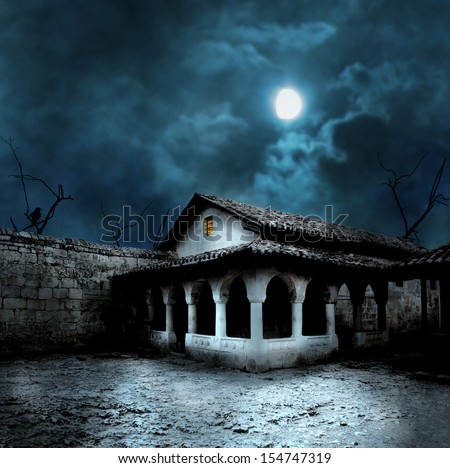 Scary dark courtyard in the ominous moonlight night in a cold Halloween
