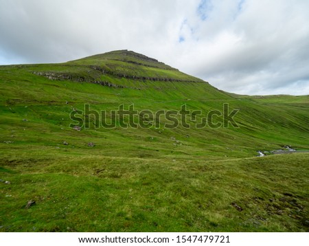 Faroe Islands. Green grass slope of mountain Royalty-Free Stock Photo #1547479721