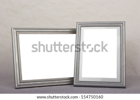 Blank silver picture frames on gray background
