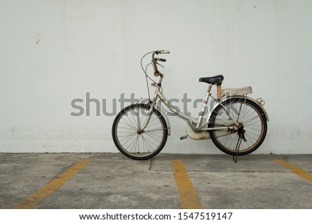 Old rusty vintage bicycle at bicycle parking. Eco friendly and urban lifestyle concept.

